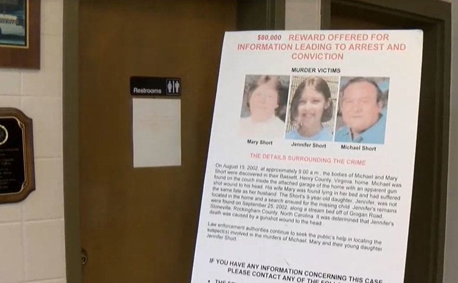 Inside the police station, a poster offers a reward for information.