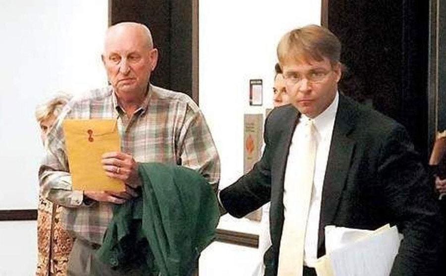 Frank Cassell, accompanied by his attorney, arrives at the courthouse.