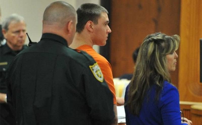 Tyler Hadley and his lawyer stand in court.
