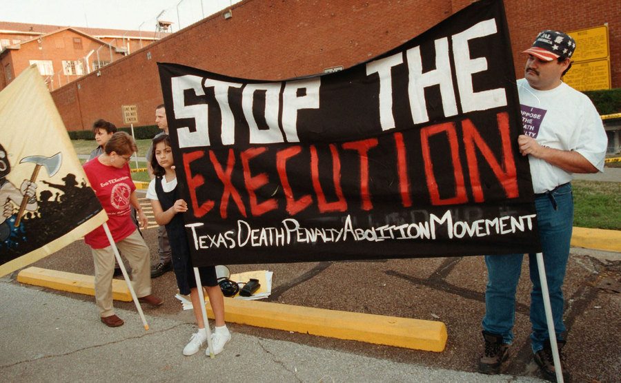 Protesters stand outside the Texas prison.