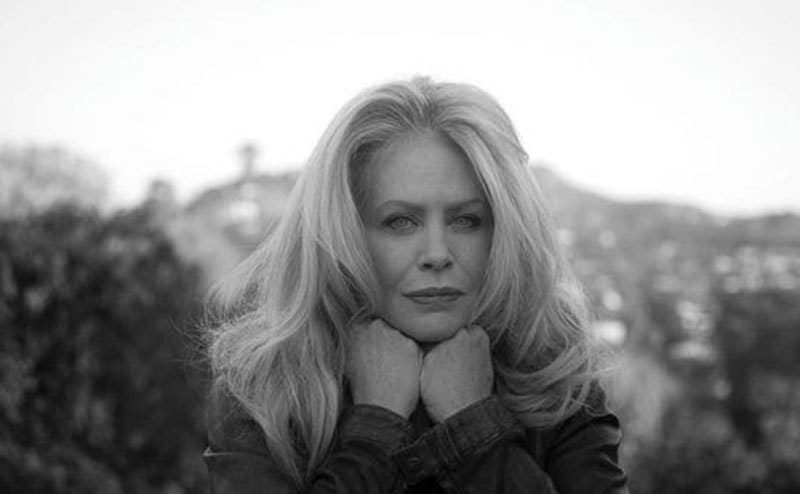 A portrait of Beverly D’Angelo in nature.