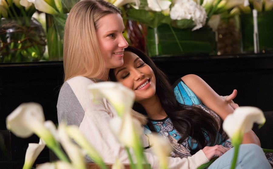 Naya Rivera leaning on Heather Morris.