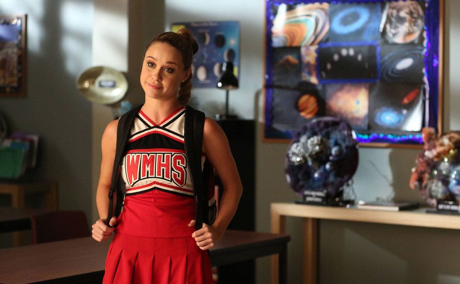 Becca Tobin in a cheerleader uniform on the set of Glee.