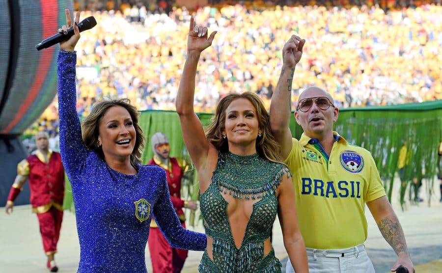 Claudia Leitte, Jennifer Lopez, and Pitbull wave to the fans at the World Cup.