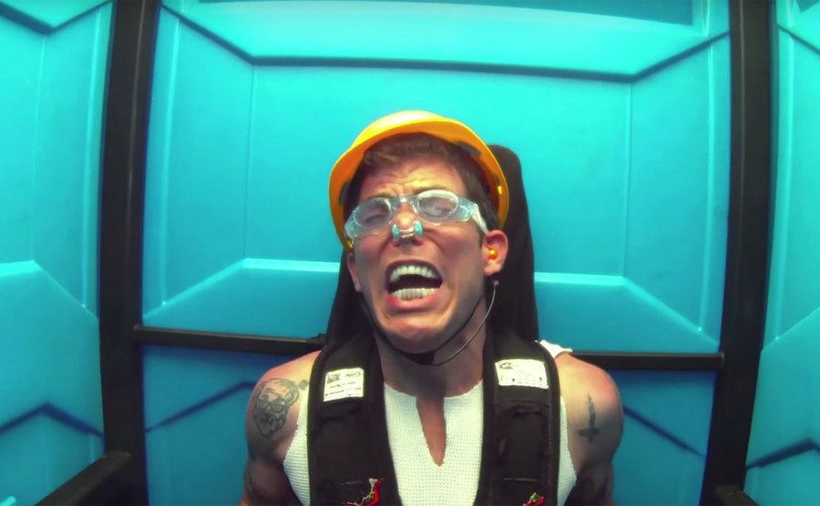 Steve-O sitting inside the portable toilet. 