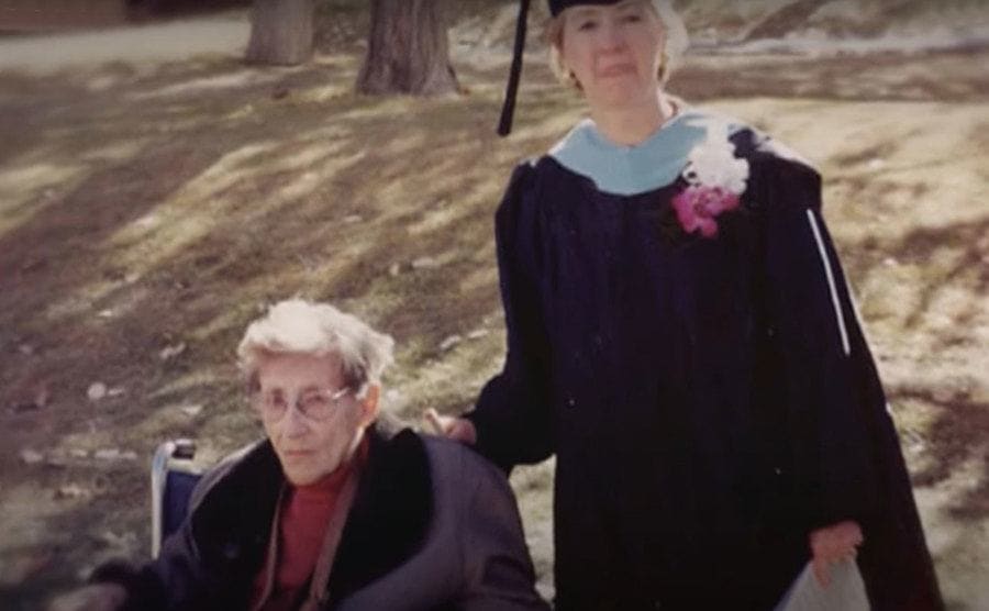 Judy stands next to Stella, who is sitting in a wheelchair.