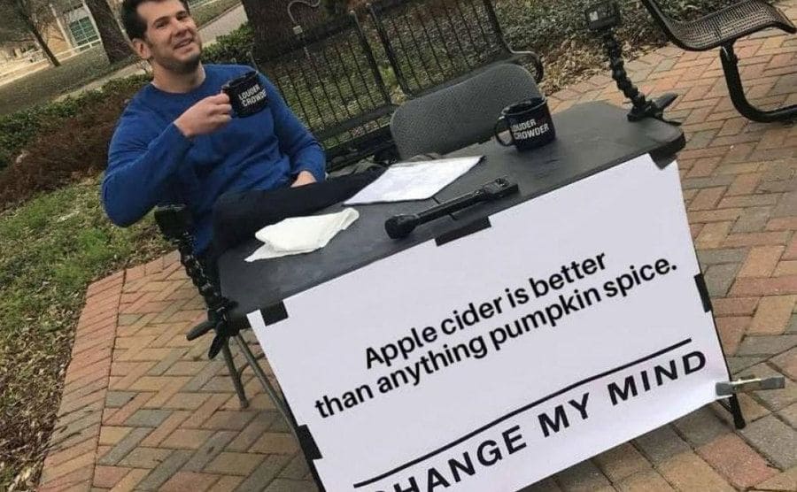 Steven Crowder, a conservative podcaster, sits at a desk.