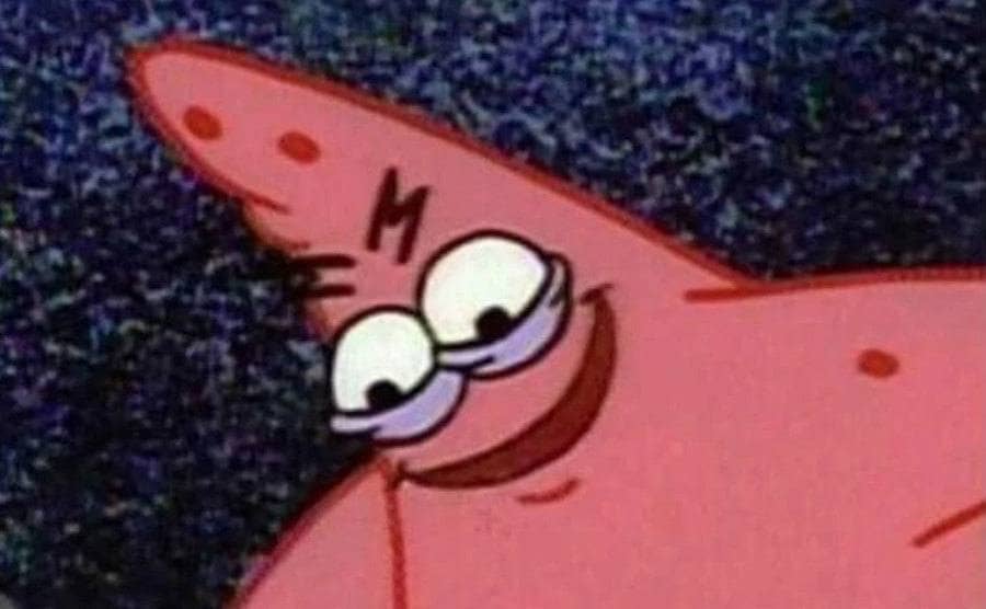 Patrick wears a wicked smile on his face.