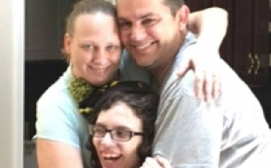 A picture of Shauna and Tony Burns embracing Hailey.