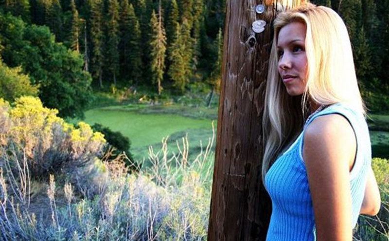 A portrait of Jodi contemplating a natural landscape.
