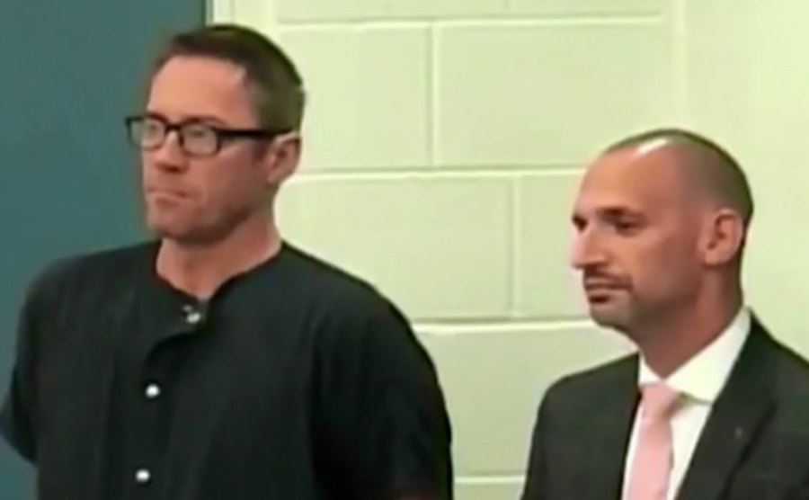 David and his attorney stand in court.