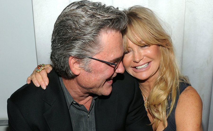 Kurt Russell and Goldie Hawn embrace each other backstage.