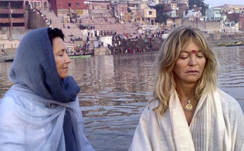 Hawn and another woman meditate on the waterfront.