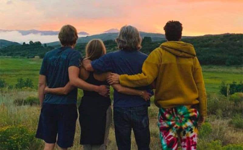 Hawn and her family pose together, looking at the sunset.