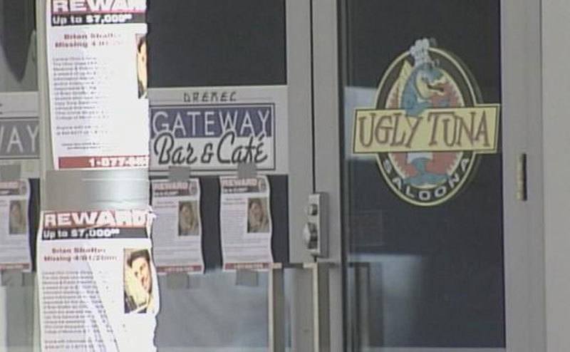 Missing person flyers are hung on poles outside the Ugly Tuna Saloona.