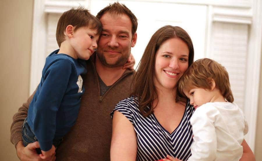 Alexis poses with her husband, Eric, and their sons.