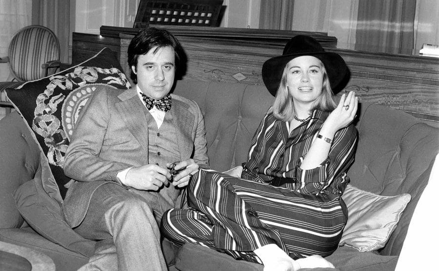 Peter Bogdanovich and Cybill Shepherd sit on a couch.