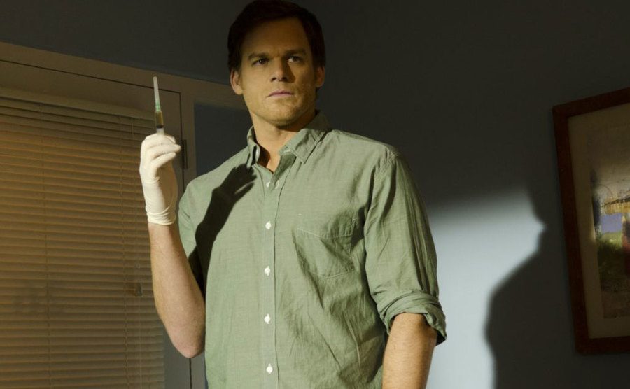A still of Michael C. Hall as Dexter holding a syringe.