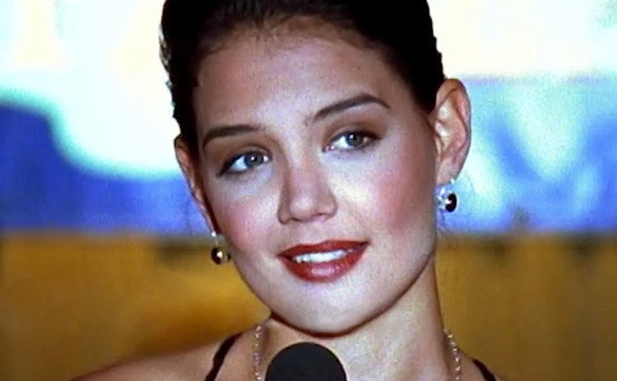 Katie Holmes sings in a still from the series.
