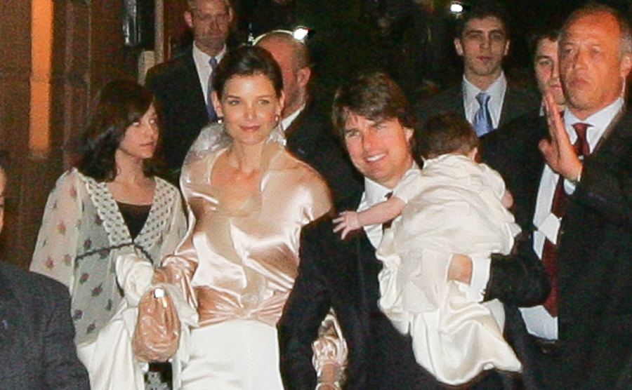 Holmes, Suri, and Cruise walk the street in Italy.