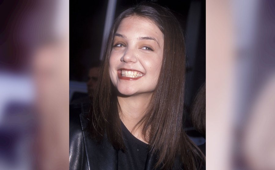 Katie Holmes smiles at the camera.