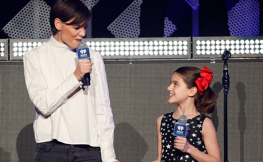 Holmes and Suri perform on stage together.