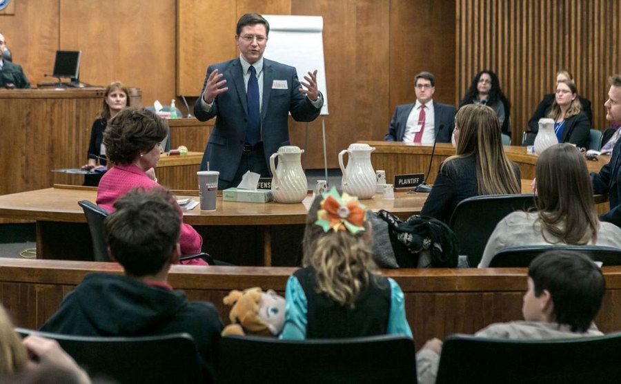 A young girl sits in court. 