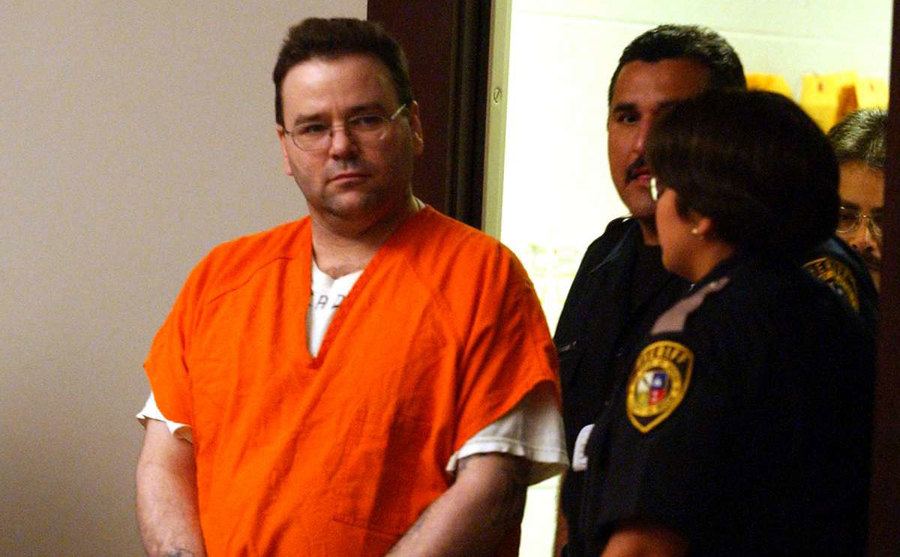 Sells enters court in handcuffs. 