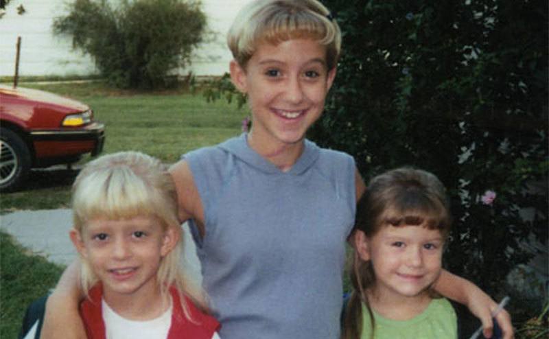 Krystal Surles poses for a photo with her younger sisters, Marque and Amber. 