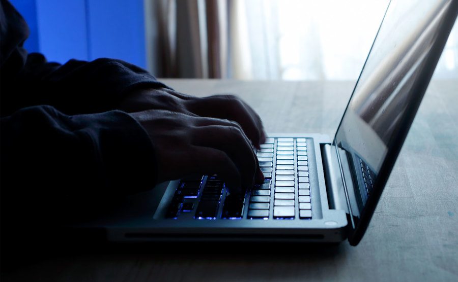 Aman types away on a computer. 