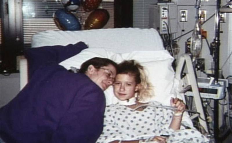 Krystal is in a hospital bed after Sells’ Attack. 