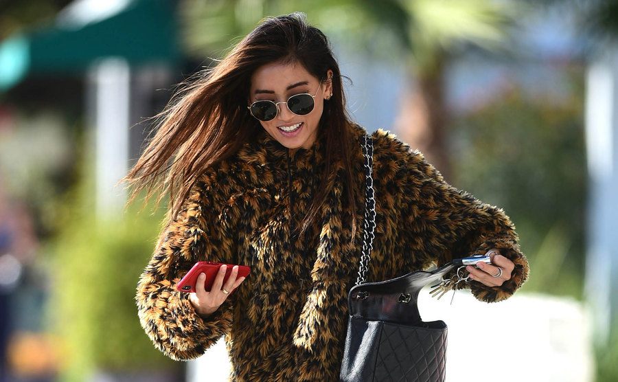 Brenda Song walks the street.