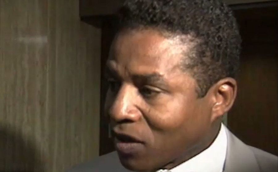 A still of Jackie Jackson speaking to the media outside the courtroom.