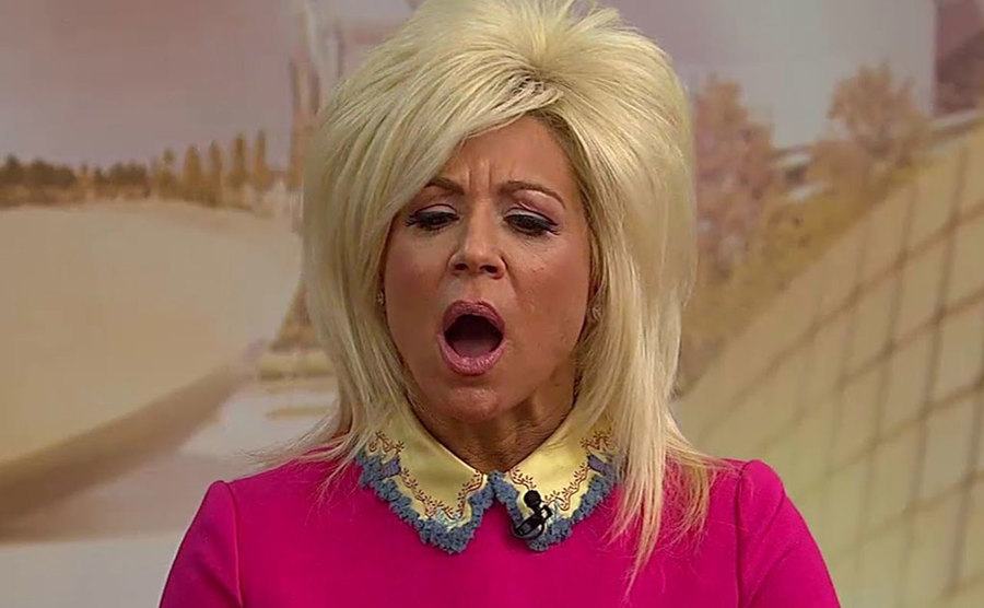 A still of Theresa Caputo speaking on television.
