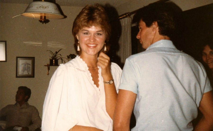 Sherri and John dance together at a party.