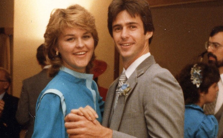 John and Sherri dance together during a house party.