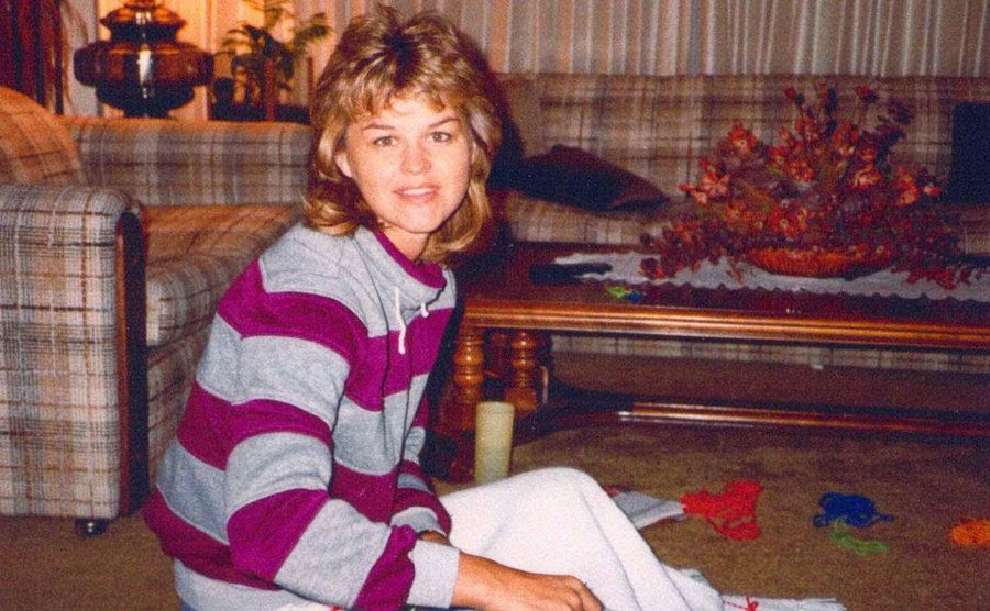 Sherri is knitting in her living room.
