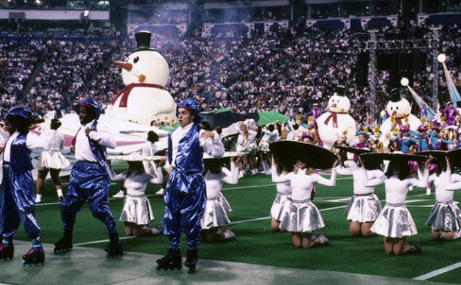 Skaters, dancers, and snowmen grace the SuperBowl field.
