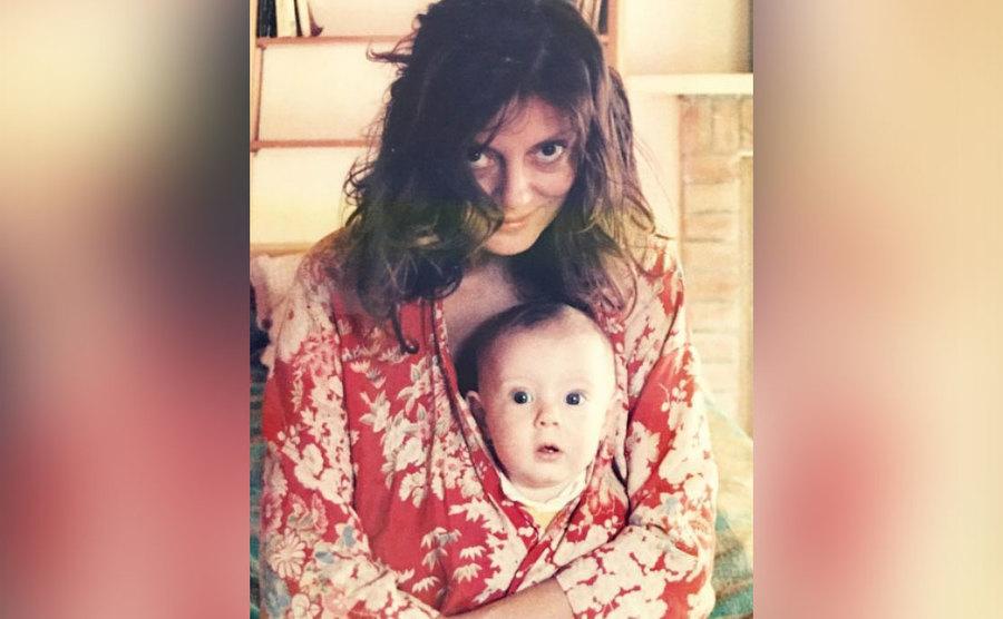 Susan holds her baby girl in her shirt.