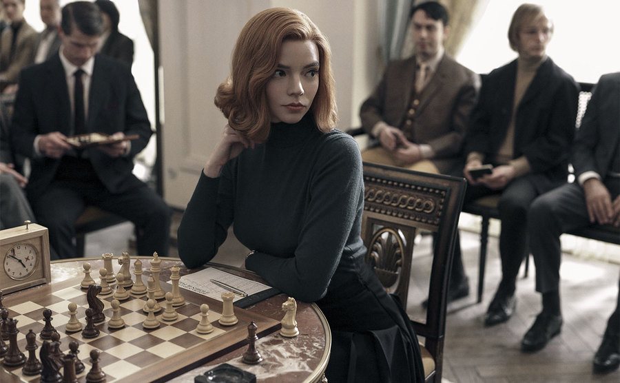Anya Taylor-Joy, as Elizabeth 'Beth' Harmon, sits down for a chess match.