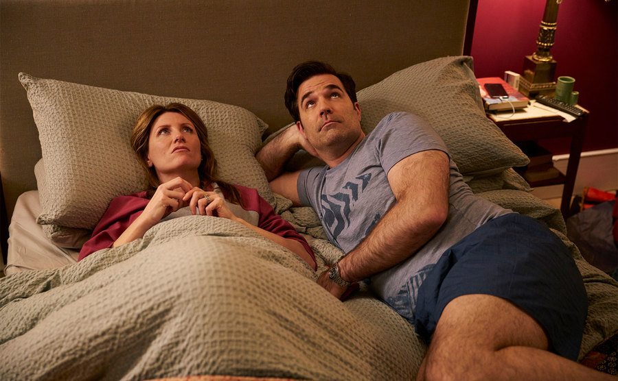 Sharon Horgan and Rob Delaney, as Sharon and Rob Norris, lay in bed staring at the ceiling.