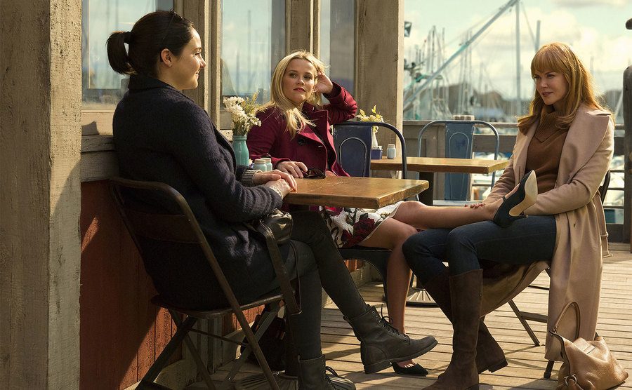 Reese Witherspoon, Nicole Kidman, and Shailene Woodley sit at a café in a still from the show.