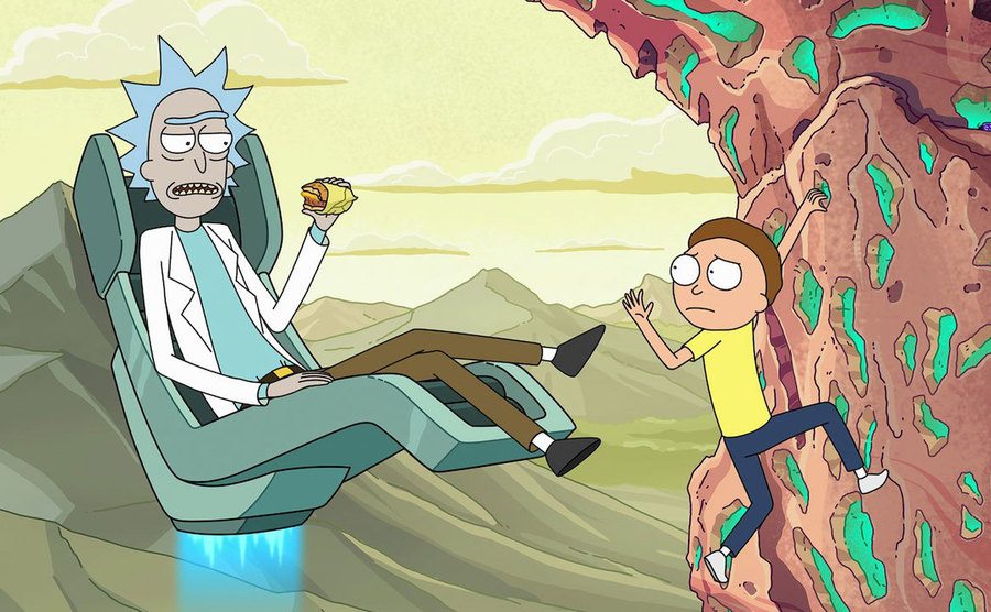 Morty climbs up a mountain as rick flies up in a hoverchair.