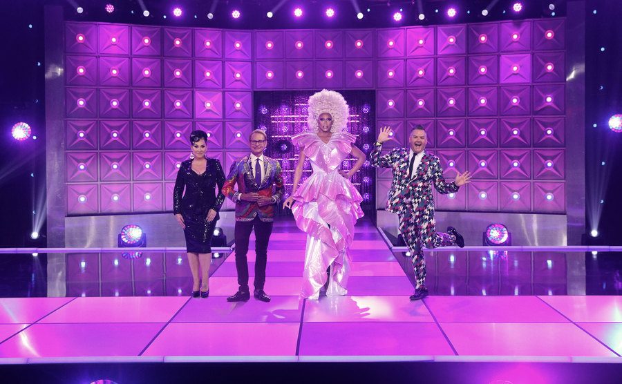 Michelle Visage, Carson Kressley, Rupaul, and Ross Mathews stand on the main stage.