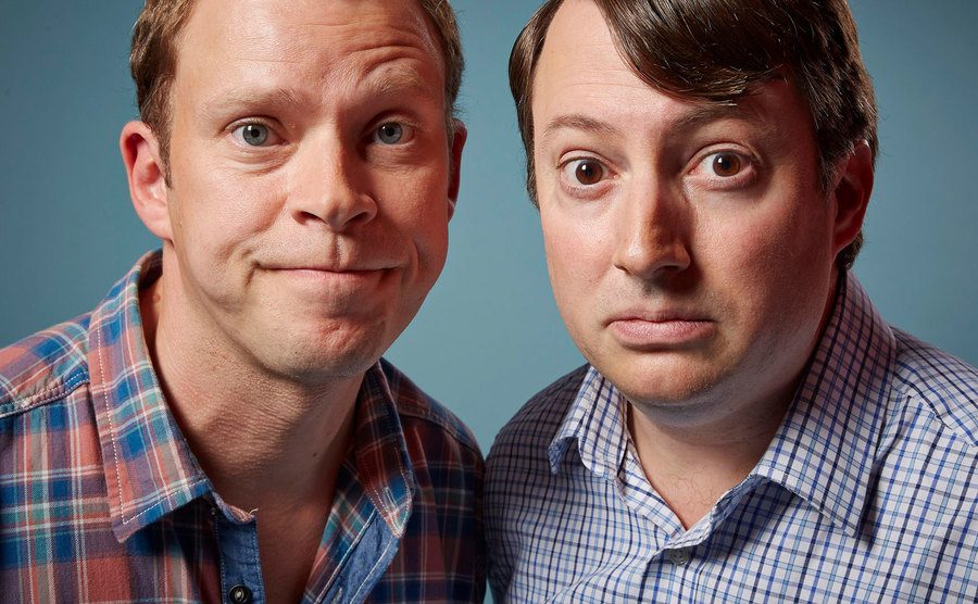 David Mitchell and Robert Webb pose for a studio portrait.