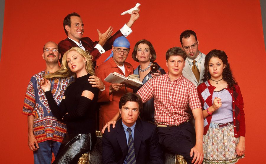The cast of Arrested Development poses for a studio portrait.