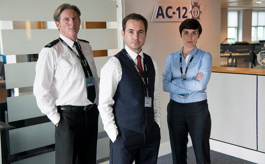 Adrian Dunbar, Martin Compston, and Vicky McClure pose for a pormo shot.
