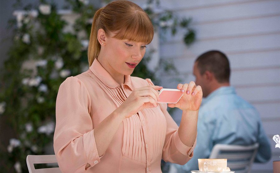 Bryce Dallas Howard takes a picture of her coffee in an episode of Black Mirror.