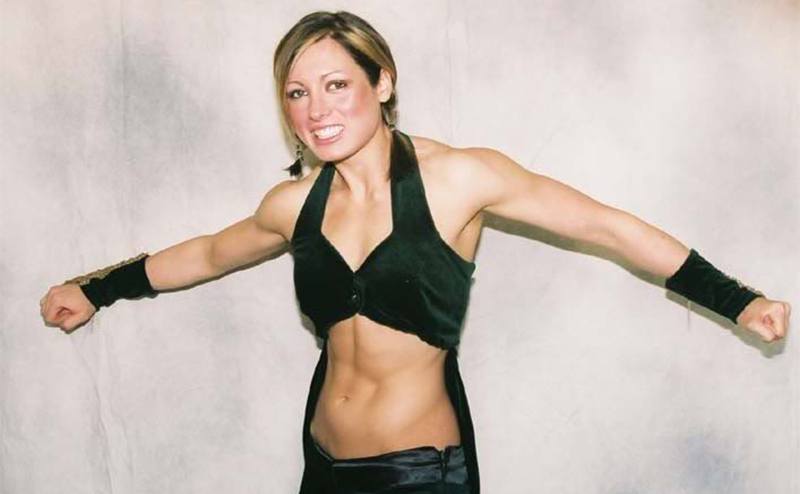 A very skinny-looking Becky Lynch poses for a picture.