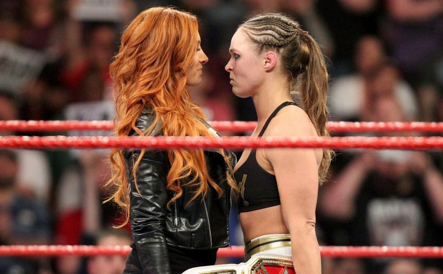 Becky Lynch stares down Ronda Rousey.